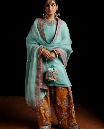 Front view of ice blue raw silk Mehndi suit with embellished shirt and mustard shalwar