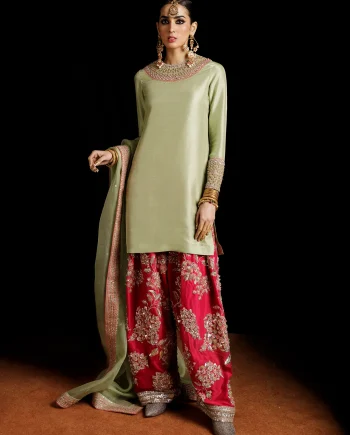 Front view of pistachio green raw silk Mehndi suit with embellished shirt and hot pink shalwar